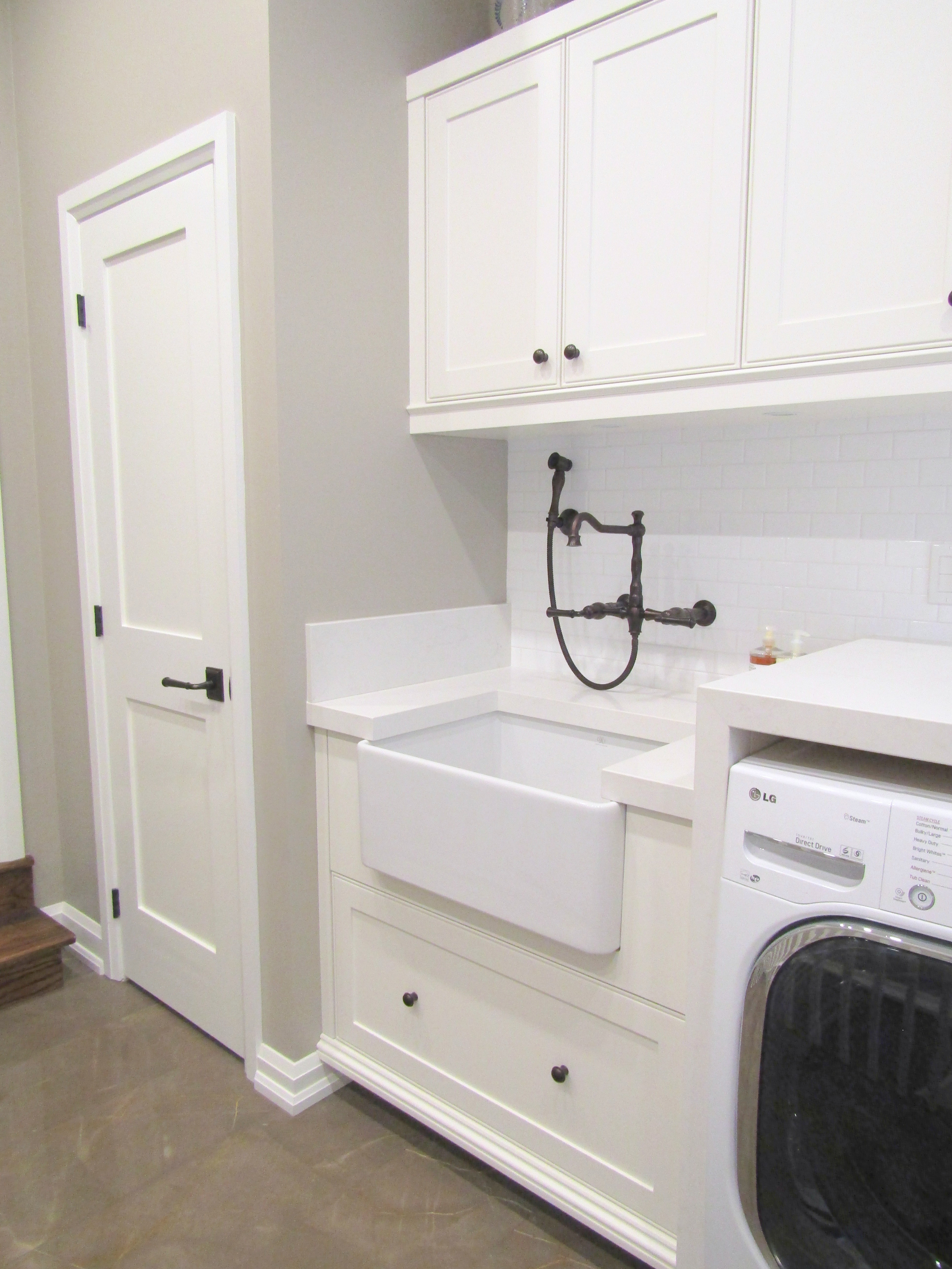Laundry room with washer and deep white sink